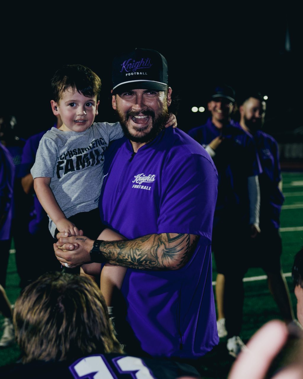 Jacob Rutter celebrates with son and team after win against WC